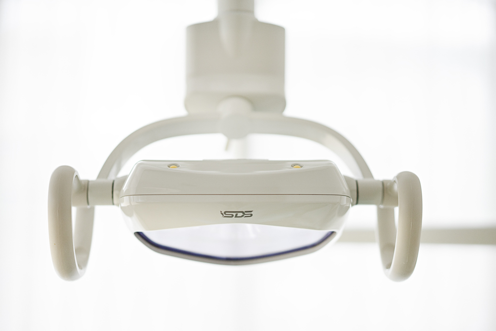 Overhead treatment light in a Milk Orthodontics treatment bay
